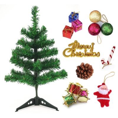 Ascension mini artificial green Christmas tree displayed alongside festive ornaments including glitter baubles, mini gifts, drums, and a Santa figure.