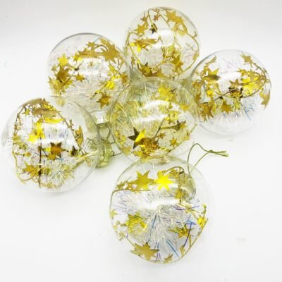 Six clear gold star Christmas baubles filled with iridescent tinsel resting on a white background.