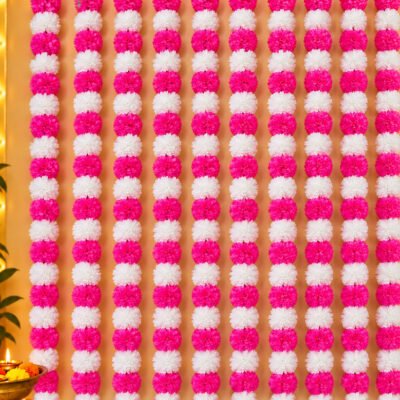 Pink Marigold Garland Strings pack of 10 hung vertically side by side as a full wall backdrop with pink and white pom-pom flowers.