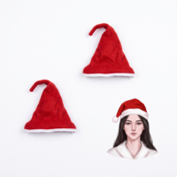 Three Ascension miniature Christmas ornaments featuring two red Santa hats and one festive character figure.