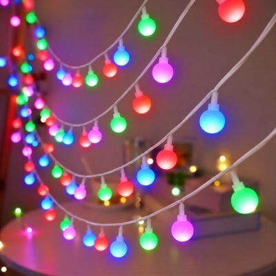 Ascension multicolor globe string lights draped gracefully over a decorative table setup
