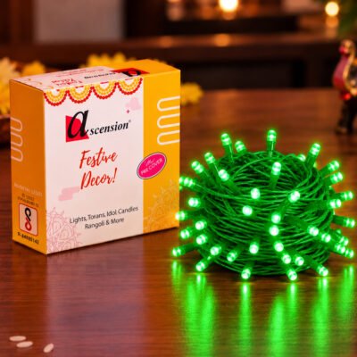 Ascension festive decor green LED string lights bundled beside product packaging on a wooden table