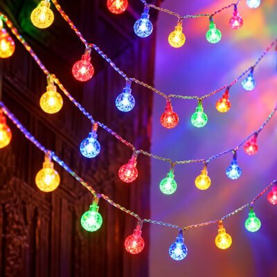 Draped strands of vibrant multicolor crystal globe string lights glowing with red, blue, green, and yellow LEDs.