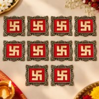 Ten square red and gold Swastik decor tiles arranged neatly on a festive beige surface.