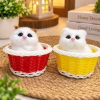 Two realistic plush kittens sit inside red and yellow woven baskets on a woven mat.