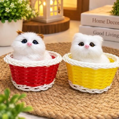 Two realistic plush kittens sit inside red and yellow woven baskets on a woven mat.